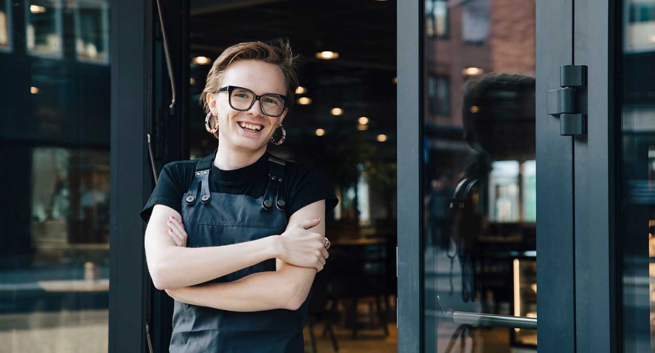 lgbtq business owner in front of store