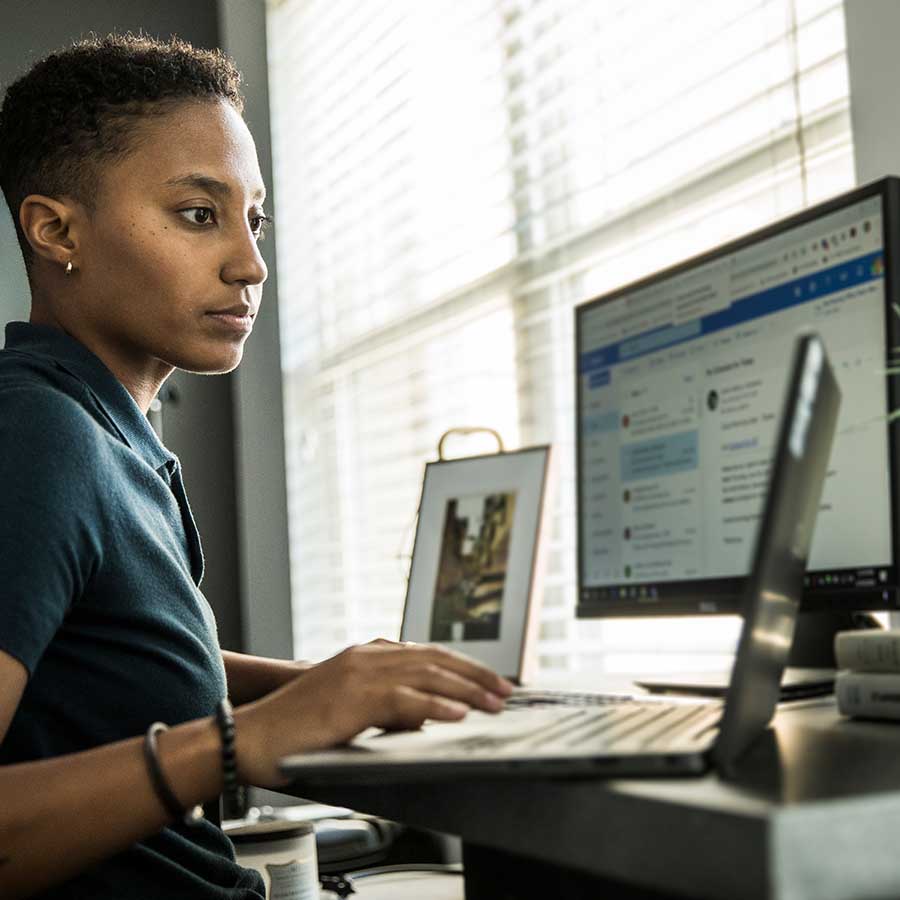 Young woman working on desktop computer in office