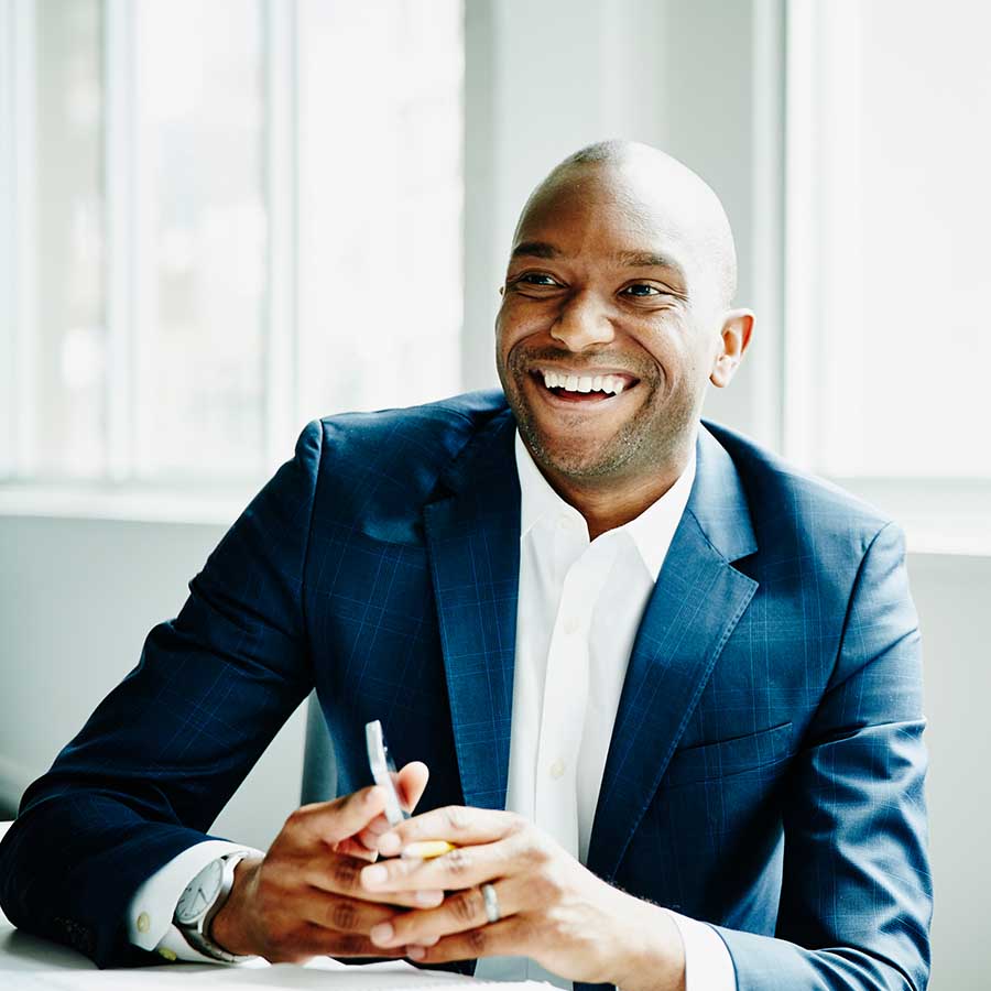 Smiling businessman in discussion at workstation